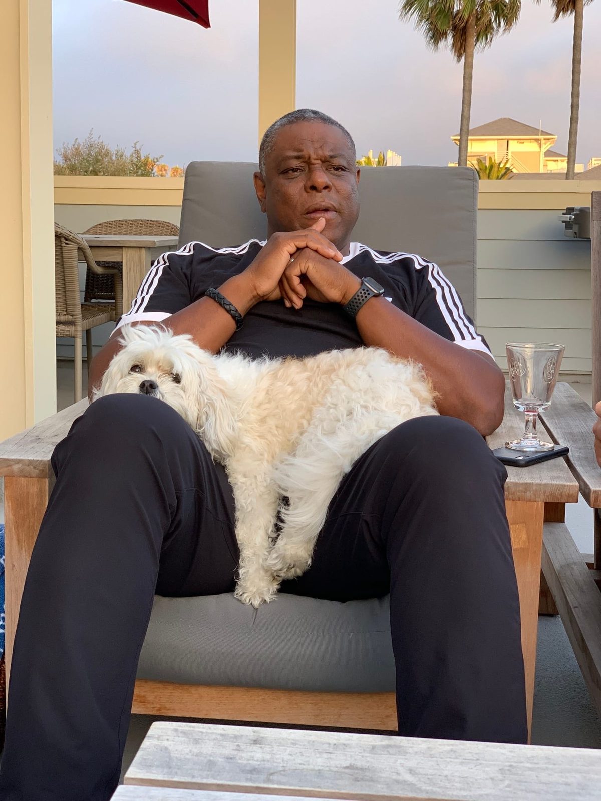 Wayne Purboo with Gloria the dog on a terrace in Santa Monica